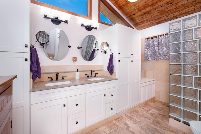 bathroom featuring vanity, wood ceiling, vaulted ceiling, and walk in shower