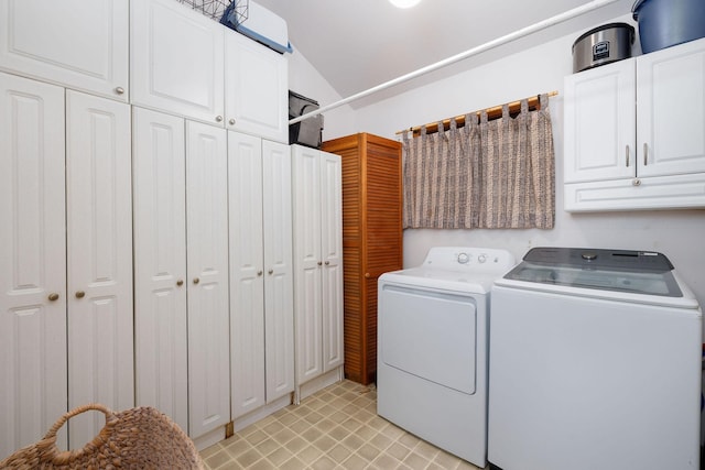 laundry room featuring cabinets and washing machine and clothes dryer