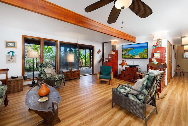 living room featuring beam ceiling, ceiling fan, and light hardwood / wood-style floors