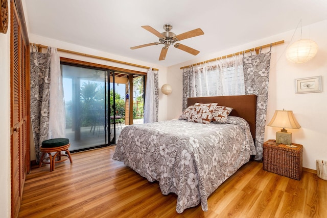 bedroom featuring hardwood / wood-style floors, ceiling fan, and access to outside