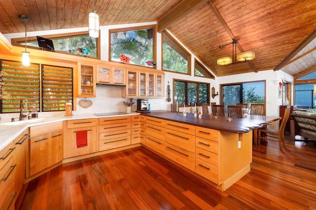 kitchen featuring beamed ceiling, high vaulted ceiling, decorative light fixtures, black electric cooktop, and wood ceiling