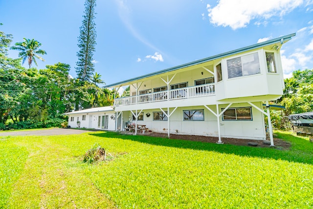 back of property featuring a lawn