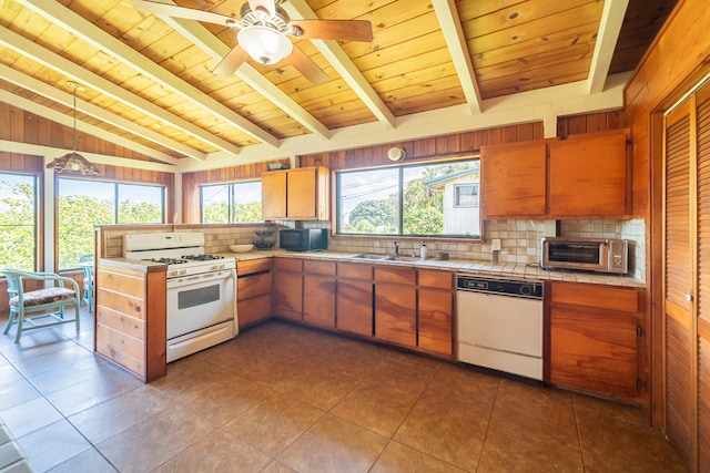 kitchen featuring hanging light fixtures, lofted ceiling with beams, white appliances, wooden walls, and wood ceiling