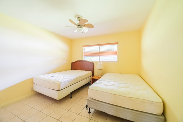 bedroom with ceiling fan and light tile patterned floors