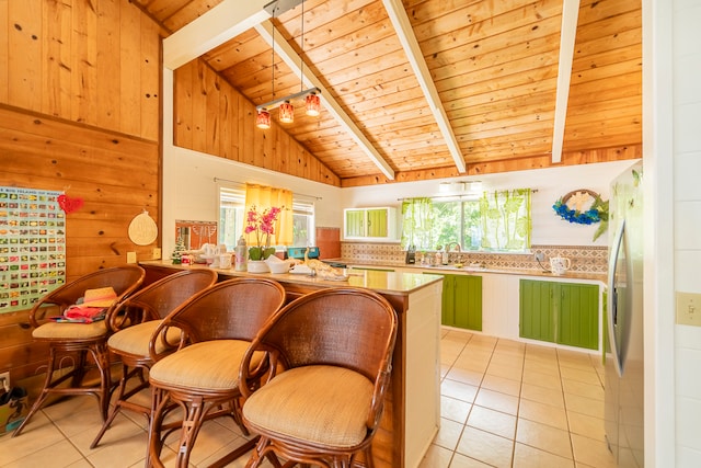 kitchen featuring stainless steel fridge, wood ceiling, sink, beam ceiling, and wood walls