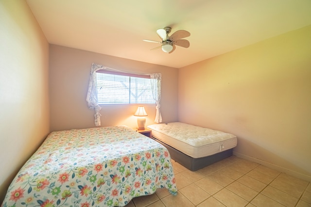 tiled bedroom with ceiling fan