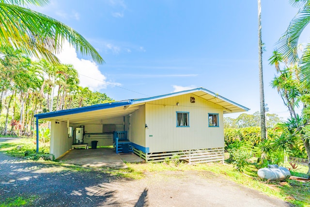 view of side of home with a carport