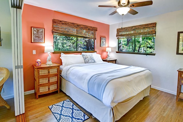 bedroom with ceiling fan and light wood-type flooring