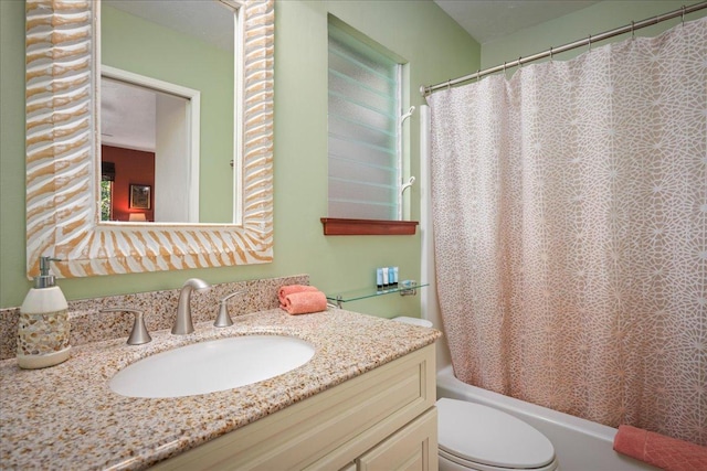 full bathroom featuring shower / bath combo, vanity, and toilet