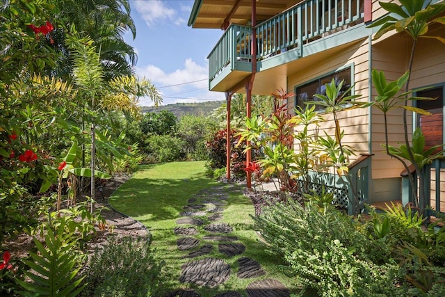 view of yard with a balcony