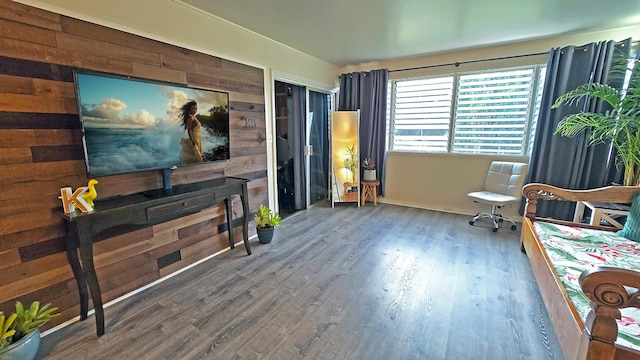 sitting room featuring wooden walls and hardwood / wood-style flooring