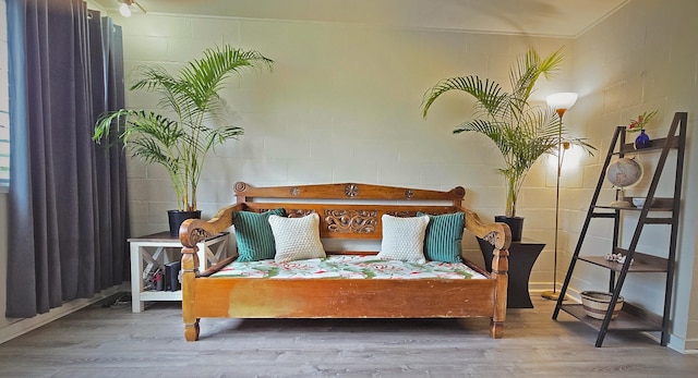 bedroom with hardwood / wood-style flooring and ornamental molding