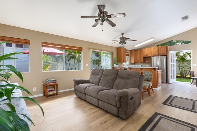 living room featuring light hardwood / wood-style flooring and vaulted ceiling