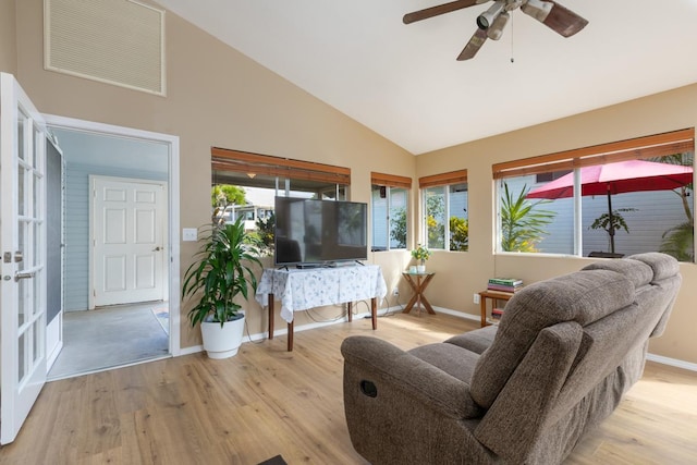 living room featuring high vaulted ceiling, light hardwood / wood-style floors, and ceiling fan