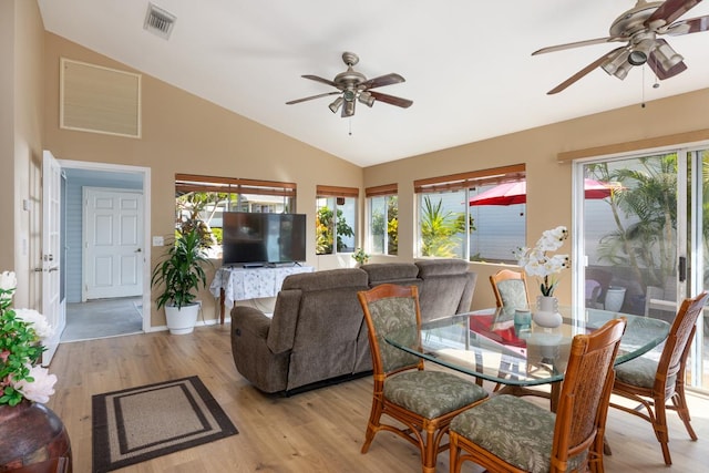 dining room featuring ceiling fan, vaulted ceiling, and light wood-type flooring