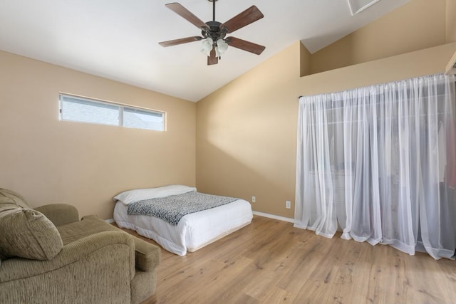 bedroom featuring ceiling fan, lofted ceiling, and light hardwood / wood-style flooring