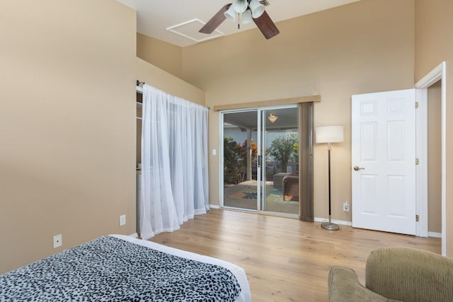 bedroom featuring ceiling fan, access to outside, high vaulted ceiling, and light hardwood / wood-style flooring