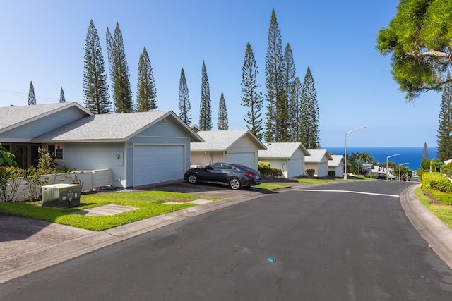 view of front of home featuring a garage and a water view