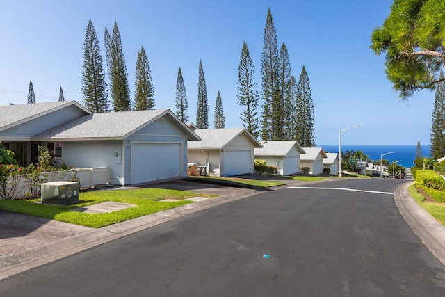 single story home featuring a water view and a garage