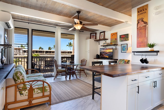 kitchen featuring ceiling fan, white cabinetry, a wealth of natural light, and wooden counters