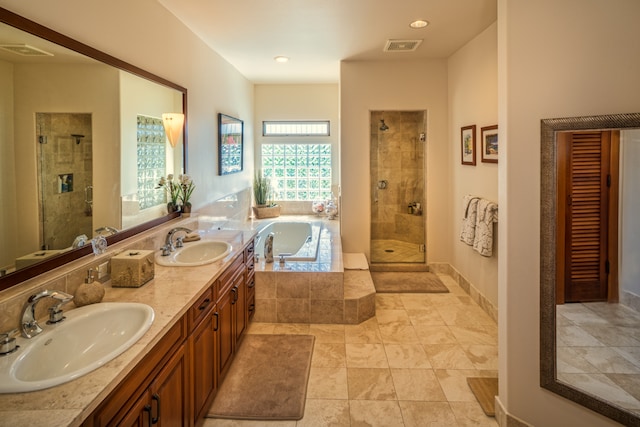 bathroom featuring vanity and shower with separate bathtub