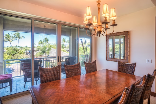 dining area with an inviting chandelier