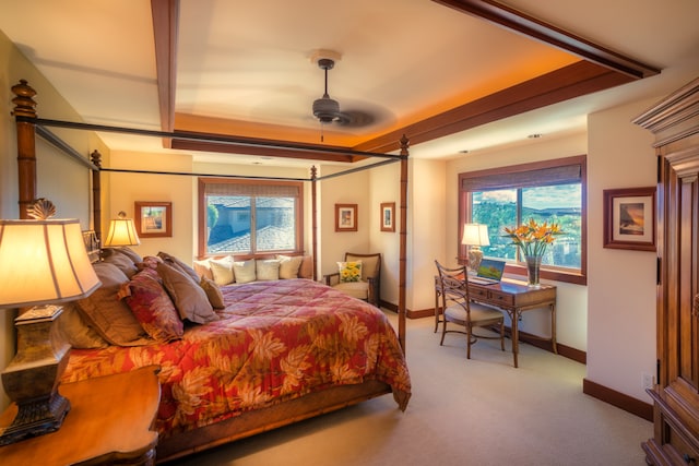 carpeted bedroom featuring multiple windows and ceiling fan