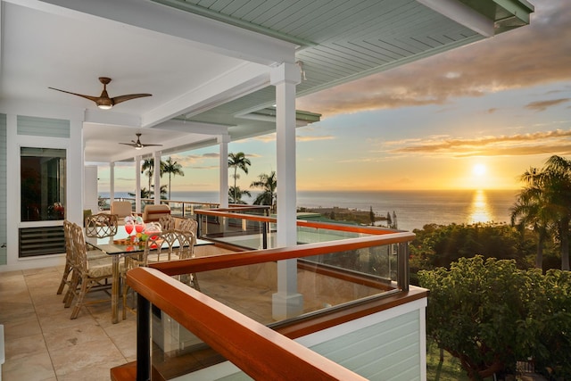 exterior space with ceiling fan and a water view