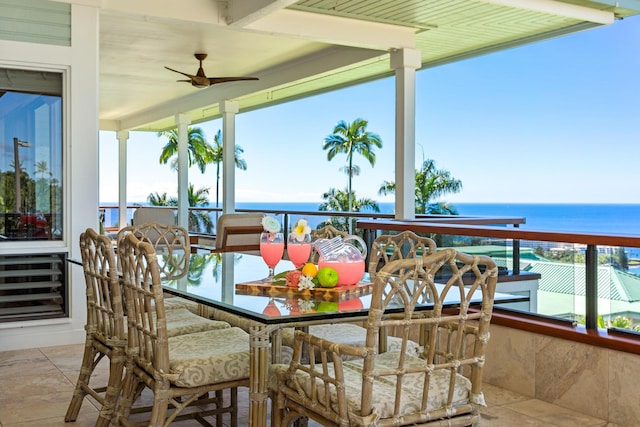 exterior space with ceiling fan and a water view