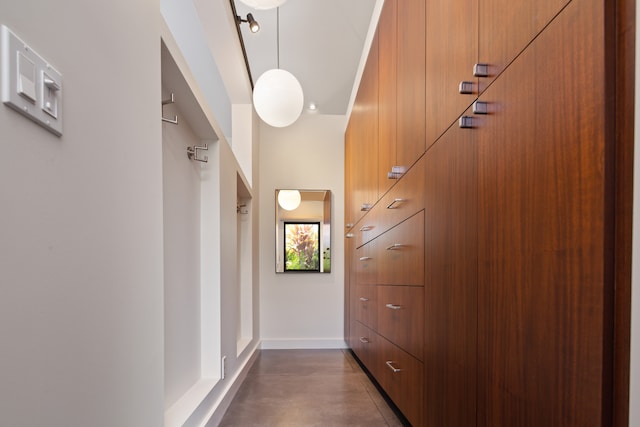 walk in closet featuring a towering ceiling