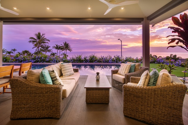 patio terrace at dusk with an outdoor living space and ceiling fan