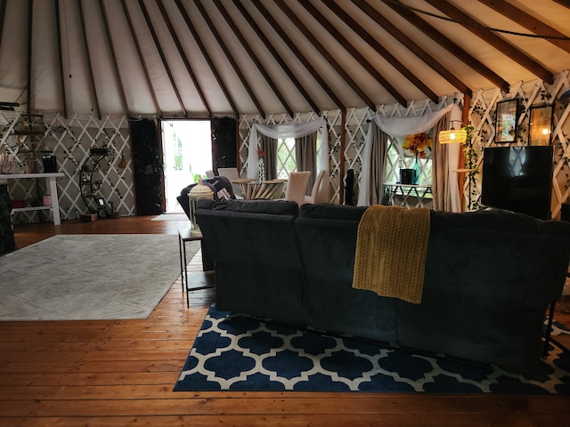 living room featuring hardwood / wood-style floors and vaulted ceiling with beams