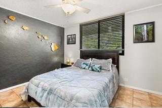 bedroom with tile patterned flooring and ceiling fan