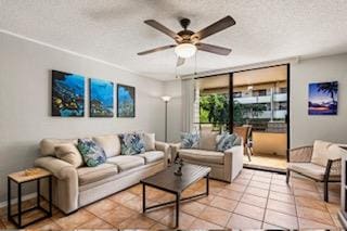 tiled living room with ceiling fan and a textured ceiling