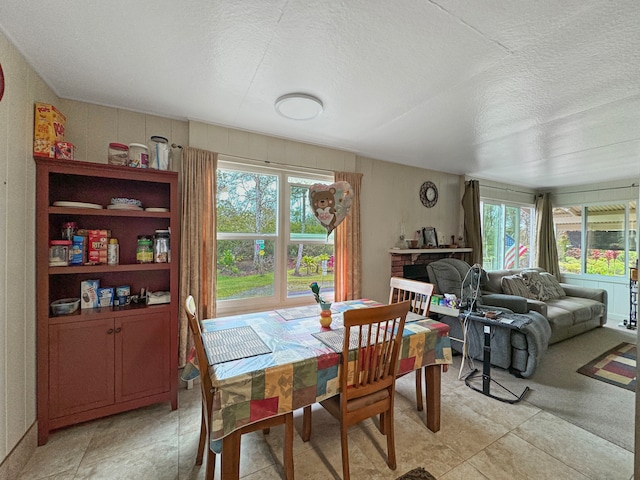 dining area with plenty of natural light and a textured ceiling