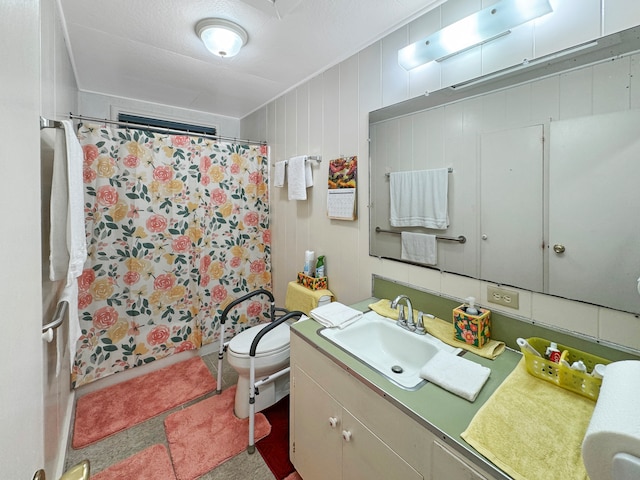 bathroom featuring vanity, toilet, curtained shower, and wood walls