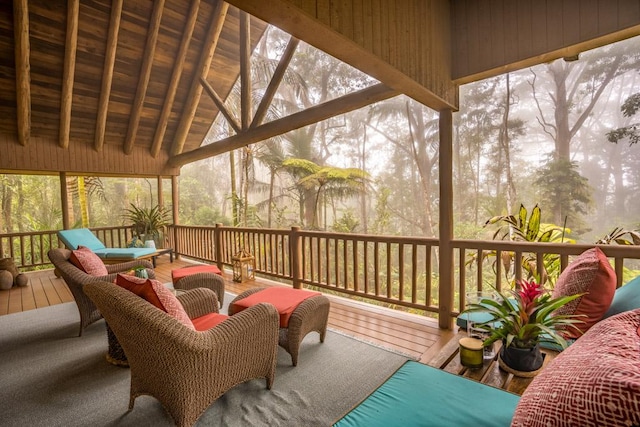 sunroom featuring vaulted ceiling with beams, a wealth of natural light, and wood ceiling