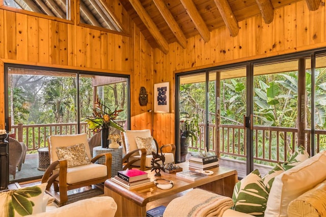 sunroom with wood ceiling, a wealth of natural light, and lofted ceiling with beams