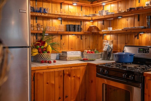 kitchen featuring tile countertops and appliances with stainless steel finishes