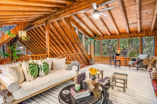 living room with ceiling fan, lofted ceiling with beams, wood walls, hardwood / wood-style floors, and wood ceiling