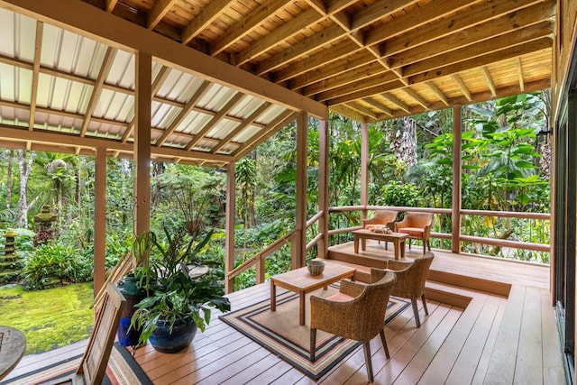 sunroom featuring lofted ceiling with beams and wooden ceiling