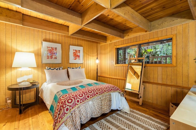 bedroom with wooden ceiling, hardwood / wood-style flooring, and wooden walls