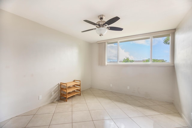 empty room featuring ceiling fan and light tile patterned floors