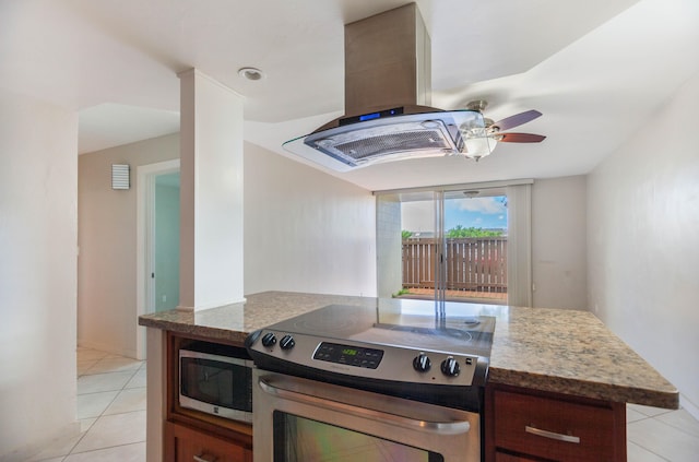 kitchen featuring stainless steel appliances, island exhaust hood, light tile patterned flooring, and ceiling fan