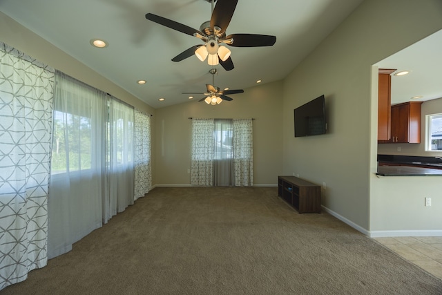 unfurnished room with light carpet, a wealth of natural light, and ceiling fan