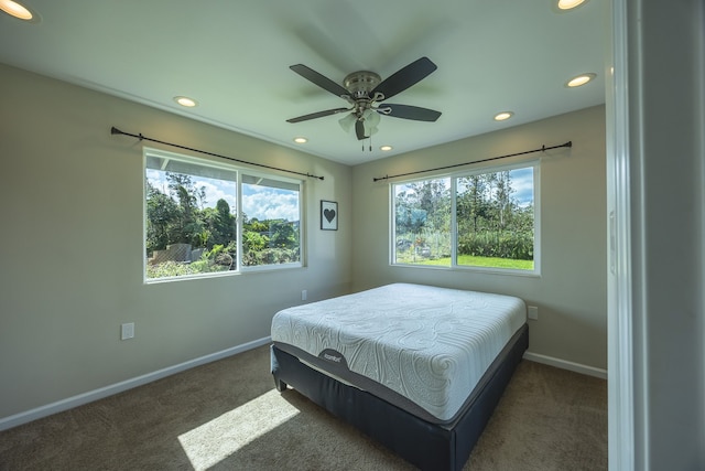 bedroom featuring dark carpet and ceiling fan