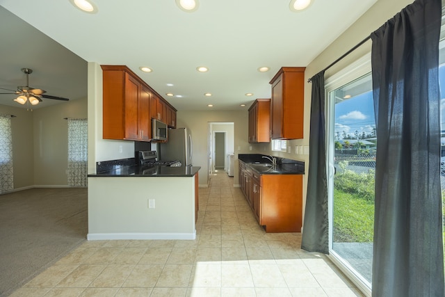 kitchen featuring plenty of natural light, light tile patterned floors, stainless steel appliances, and sink