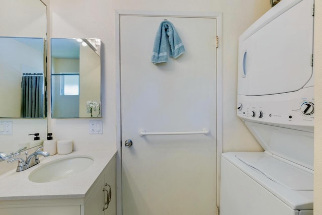 bathroom with vanity and stacked washer and clothes dryer