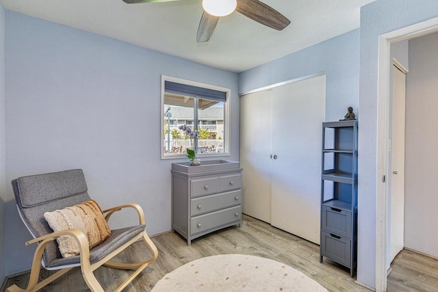 living area featuring ceiling fan and light wood-type flooring