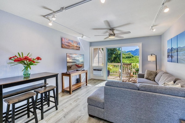 living room with ceiling fan and light hardwood / wood-style floors